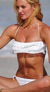 Candice Swanepoel wearing a belly chain on the beach