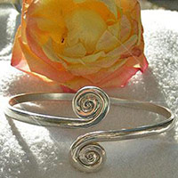Adjustable silver twirl arm cuff jewellery.
