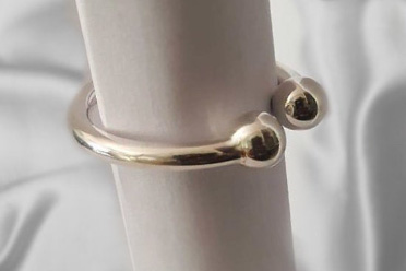 Heavy silver frenulum cock ring with two solid pressure balls