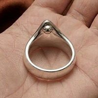 Silver glans cock ring with pressure ball in the customer's hand