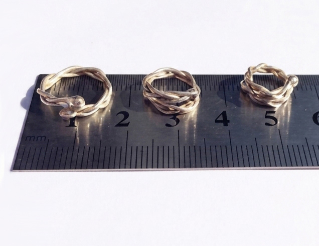 Adjustable non-piercing nipple rings shown on a ruler
