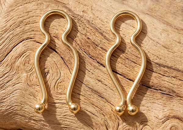 Solid gold nipple clips showing the adjustable non-piercing design